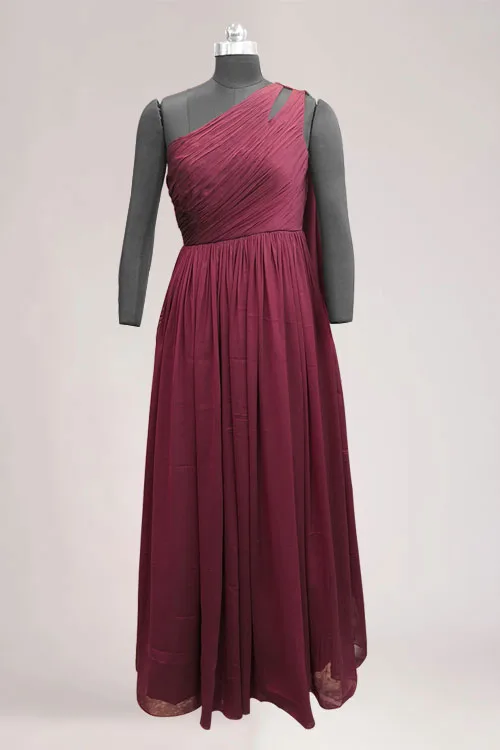 The wine Ethereal One-Shoulder gown at full length on a dress form, the ruched bodice above a gathered floor length skirt